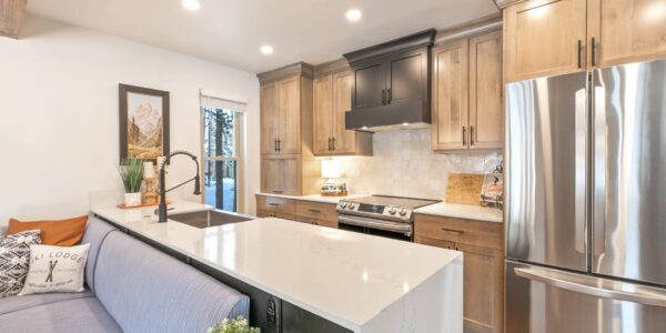 A remodeled modern kitchen with new cabinets and countertops